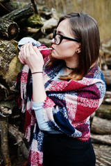 Young girl smoking cigarette outdoors background wooden stumps. Concept of nicotine addiction by teenagers.