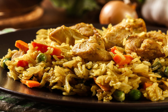 Fried rice nasi goreng with chicken and vegetables on a plate
