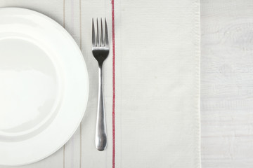 White plate, fork and napkin