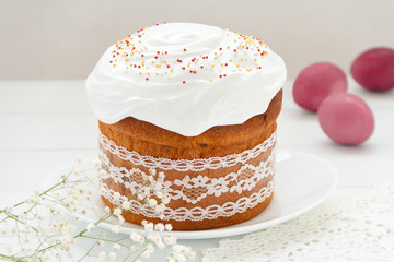 Easter cake and painted eggs on a table. Traditional orthodox christian easter food. Side view, selective focus