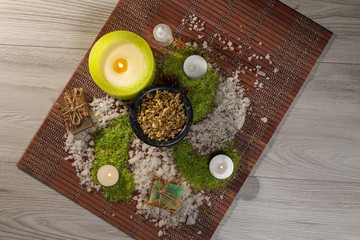 Spa nature products. Sea salt, chamomile, soap and aromatic oil on wooden background