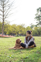 Girl and Golden Retriever, outdoors on the grass