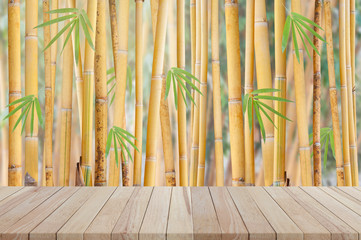 Empty wooden table with yellow bamboo tree background