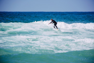 Surferboy in den Wellen in Portugal, Küste, Peniche