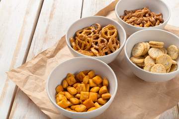 Pretzels in bowls on wooden table from above