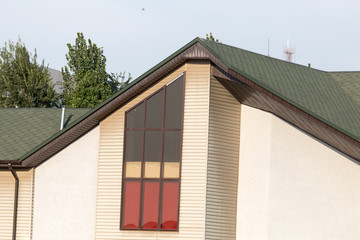 Roof of house with green tiles