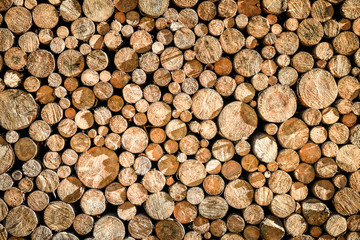 Pile or stack of natural fire wood logs texture background. Abstract photo of natural wooden logs texture.