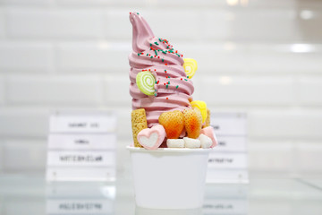 Closeup of takeaway cup with organic frozen yogurt ice cream with topping, It's delicious and...