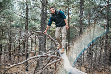 Explorer man walking in the forest