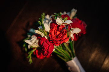 Wedding. Wedding bouquet and selective focusing rings Bouquet and accessories of bride and groom. Wedding closeup details