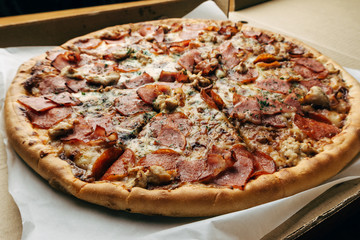 Great tasty meat pizza in a box, food delivery concept