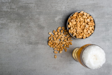Glass of beer and peanuts