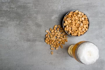 Gordijnen Glass of beer and peanuts © KariDesign