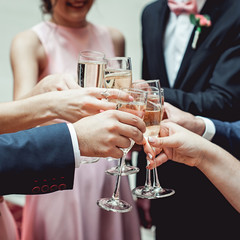 People hold in hands glasses with white wine. wedding party.