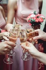 People hold in hands glasses with white wine. wedding party.