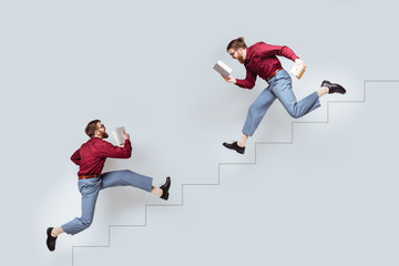 Two funny twin men with books running up and down