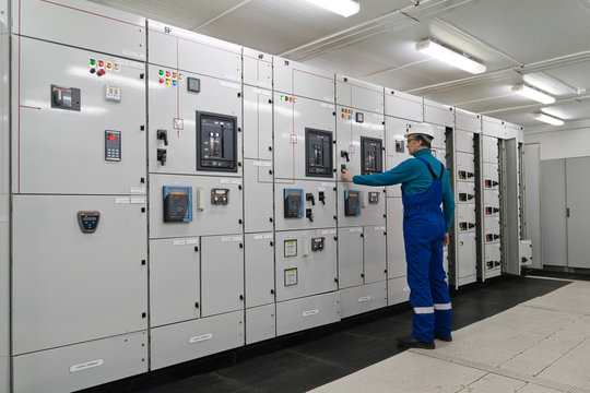 Man is in electrical energy distribution substation