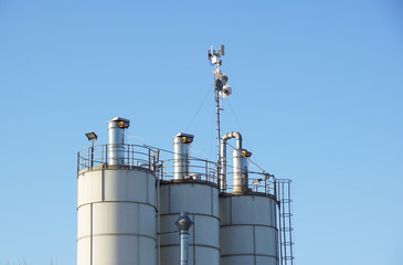Silver Grain Silos with blue sky in background
