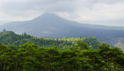 Sunrise in Amed, Bali, Indonesia. The active volcano Gunung Agung looms over the black sand beach of Jemeluk in the area known as Amed in the eastern shore of the tropical island of Bali.