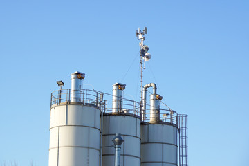 Silver Grain Silos with blue sky in background