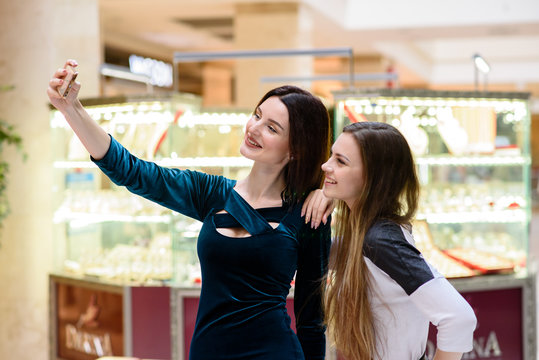 Beautiful girls doing selfi at the Mall.