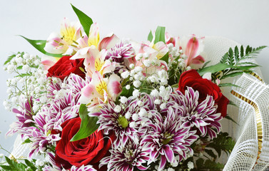 Beautiful bouquet of flowers on a white background close-up.