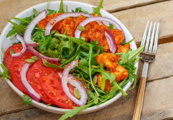 Salad with arugula and chicken. Healthy green food concept.