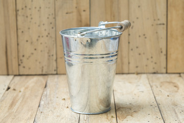 bucket of water on wood background, vintage filtered Images