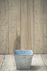 bucket of water on wood background, vintage filtered Images
