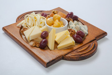 various types of cheese on a wooden board