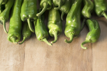 Vegetable ingredients. Green peppers on a wooden background