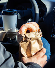 Man holding donuts craft bagcoffee cup