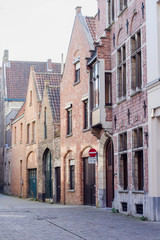Fototapeta na wymiar Architecture of narrow bicked street of Brugge town in Begium