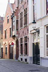 Fototapeta na wymiar Architecture of narrow bicked street of Brugge town in Begium
