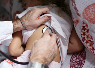 Doctor checking lungs of his patient.