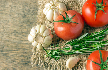 Ingredients for cooking. Tomatoes, greens, garlic.