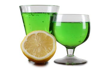 Glass cup with a cocktail and lemon on white background