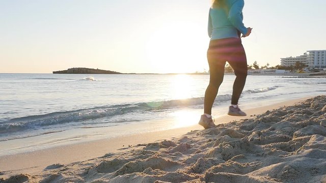 Fitness woman jogging on beach run