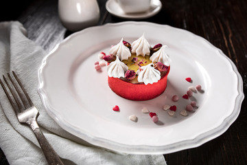 Caramel cheesecake with cream and flowers on the wooden background