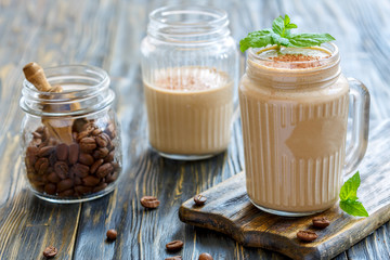 Coffee smoothie with banana and yogurt in a glass mug.