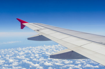 Obraz premium Clouds and sky as seen through window of an aircraft
