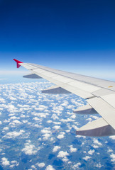 Obraz premium Clouds and sky as seen through window of an aircraft