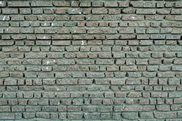 A wall made of layers of gray granite small