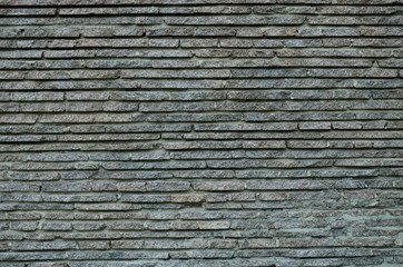 A wall made of layers of gray granite