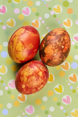 Several dyed eggs. Eggs on colorful surface. Typical Easter food.