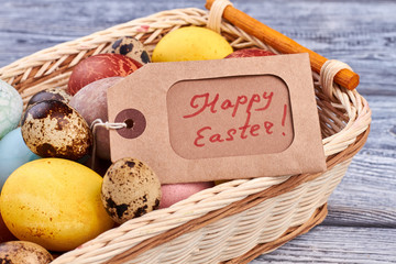 Eggs and Happy Easter tag. Light colored woven basket. How to prepare for Easter.
