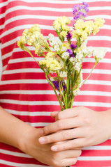 Woman holding statice flower for giving in special day