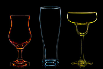 Silhouette of multicolor different glasses on black background
