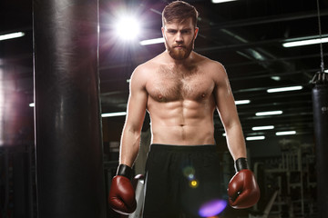 Fototapeta na wymiar Concentrated handsome young strong sports man boxer
