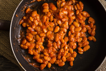 Beans in tomato in a frying pan. A delicious dish.